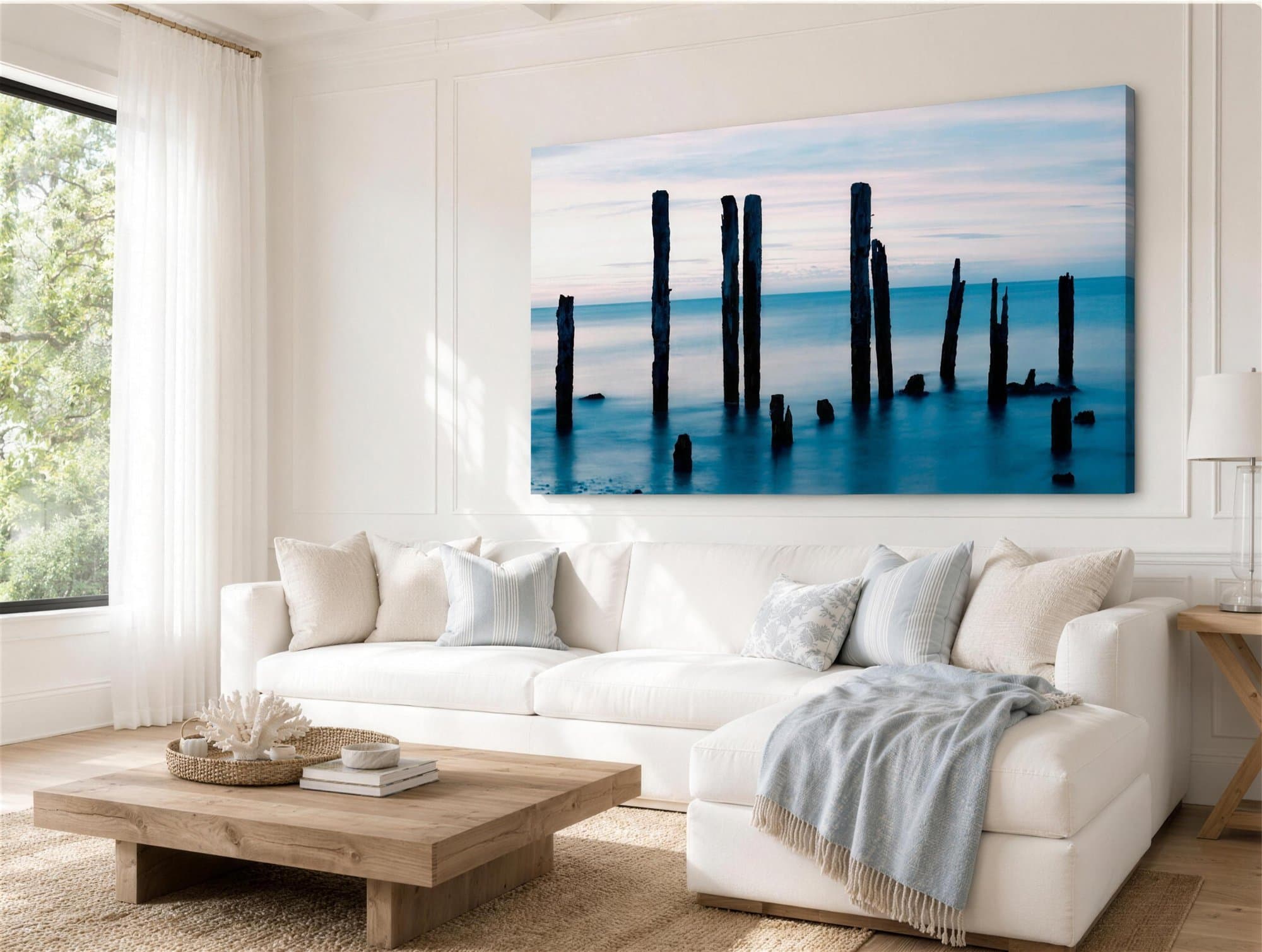 Large coastal jetty canvas print above a white sofa in a bright Australian living room